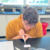 student doing pipette art