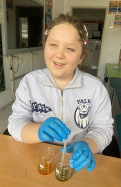 Young vision-impaired girl wearing lab gloves