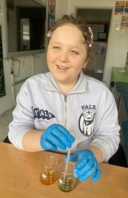 Young vision-impaired girl wearing lab gloves